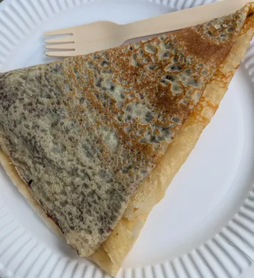 piece of cake with lots of nutella and a fork on a white paper plate