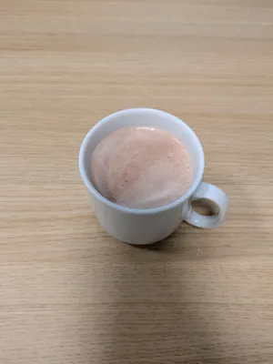 solitary cup of cocoa on a wooden table very appetising