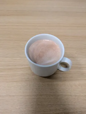 solitary cup of cocoa on a wooden table very appetising